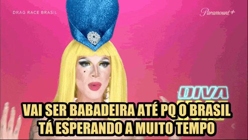 a drag queen wearing a blue hat with the words diva on the bottom