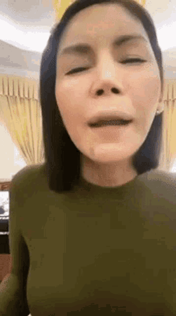 a close up of a woman 's face with her eyes closed .