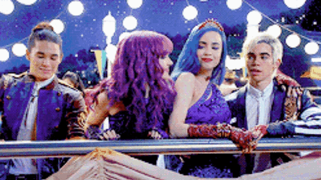 a group of people are standing next to each other on a railing .