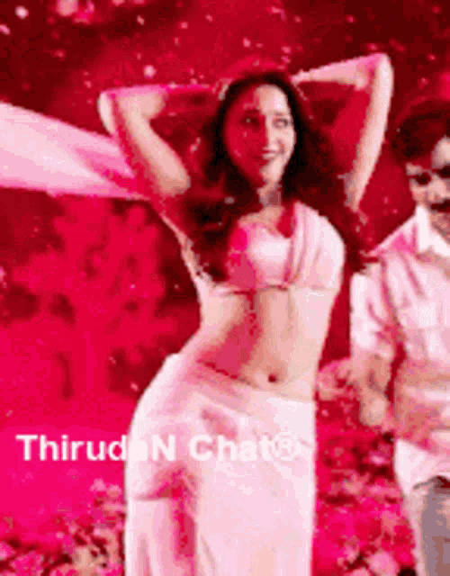 a woman in a white top and white skirt is dancing with a man