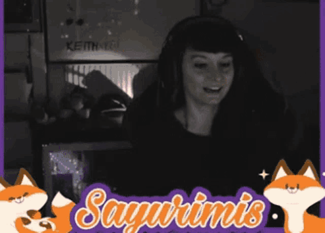 a woman wearing headphones sits in front of a computer screen with the words sayurimis written on the bottom