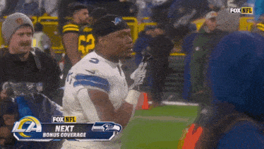 a football player on the field with a fox nfl next bonus coverage banner