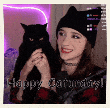 a woman holding a black cat with the words happy saturday written on the bottom