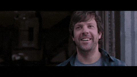 a man with a beard is smiling and says thank you dickheads