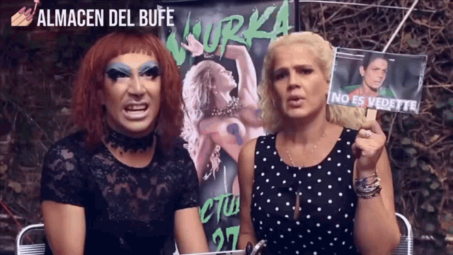 a man and a woman are standing in front of a banner that says almacen del bufe