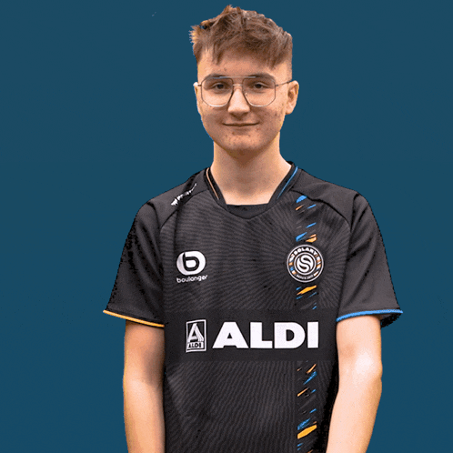 a young man wearing a black shirt that says aldi on it