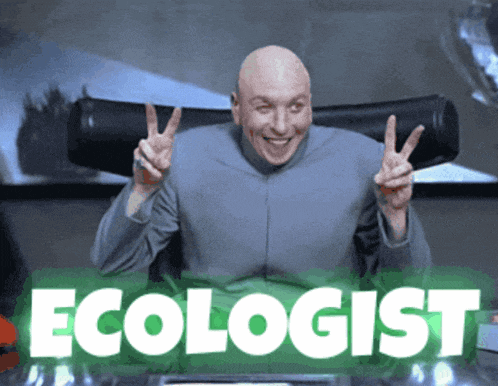 a bald man is giving a peace sign in front of a green sign that says ecologist