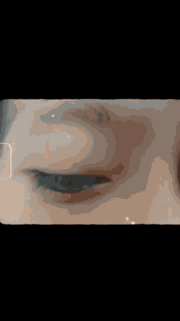 a close up of a person 's face with a black background .