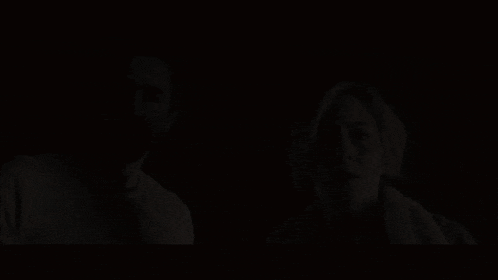 a man with a beard and a woman with blonde hair are looking at the camera