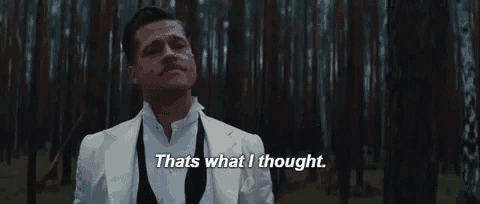 a man in a white suit is standing in a forest and saying `` that 's what i thought '' .