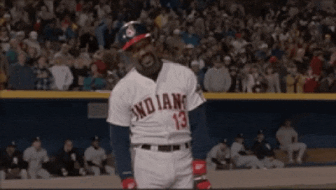 a baseball player wearing a jersey that says indians is standing on the field .