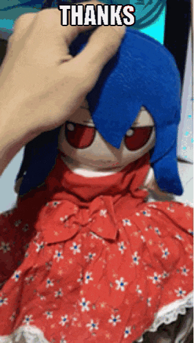 a person is petting a stuffed doll with the words thanks written on it