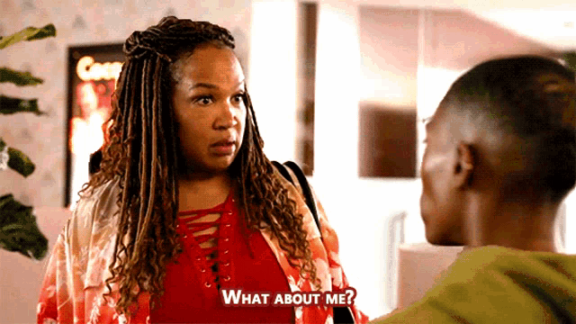 a woman with dreadlocks is talking to a man with the words " what about me " above her