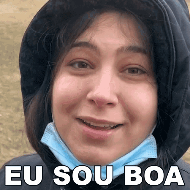 a woman wearing a hooded jacket and a face mask with eu sou boa written below her