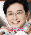 a close up of a man wearing glasses and smiling with chinese writing .
