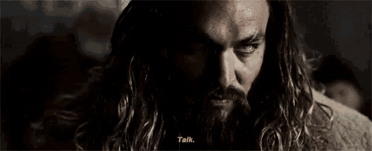 a close up of a man with long hair and a beard .