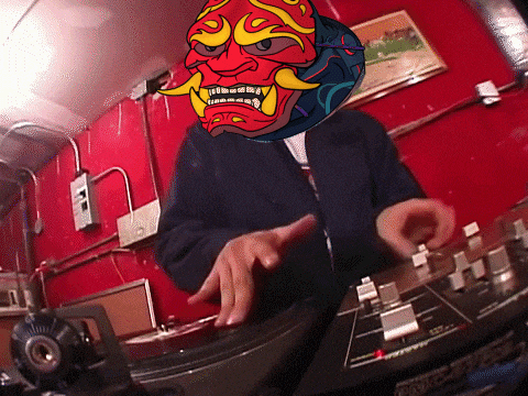 a man wearing a mask playing a record on a turntable