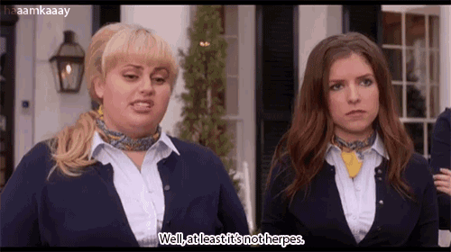 two women are standing next to each other and one of them is talking about herpes .