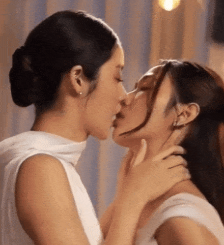 two women are kissing each other on the neck