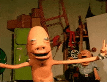 a cartoon character in a room with a green refrigerator in the background