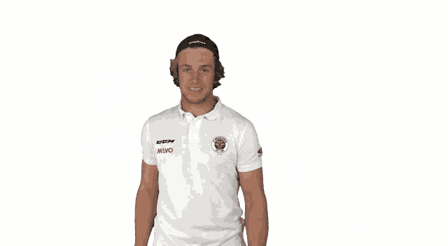 a man wearing a white shirt with the word wings on the front