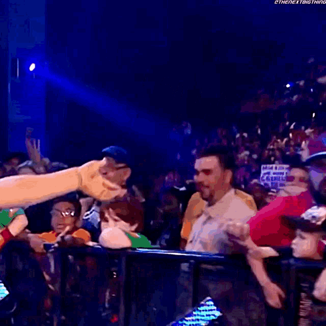 a man in a red shirt holds a sign that says sasha deserve better