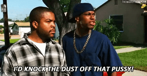 two men are standing on a sidewalk and one of them is saying i 'd knock the dust off that pussy