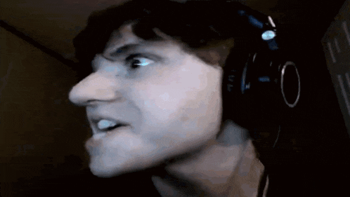 a man wearing headphones is making a face