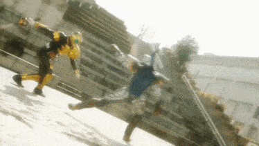 a man in a yellow costume is kicking another man