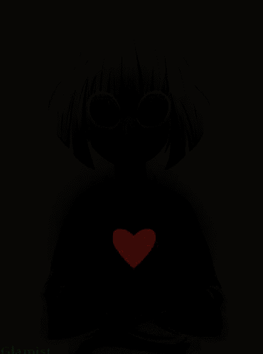 a girl is holding a heart in her hands in a dark room