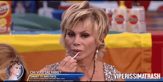 a woman eating a lollipop with the words viperissimo trash written on the bottom
