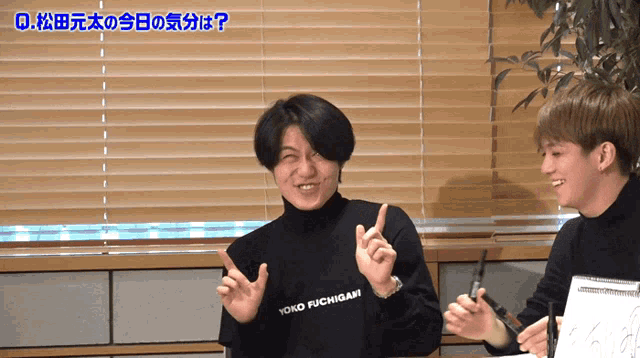 a man wearing a black yoko fuchigari sweater laughs