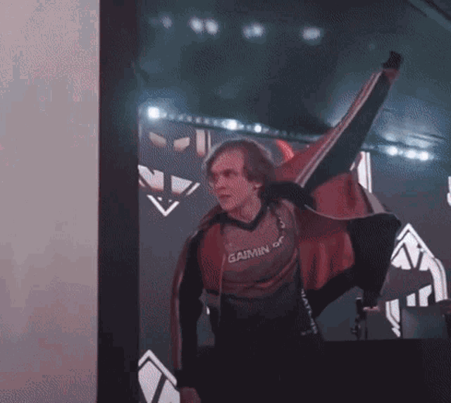 a man wearing a red jacket that says gaining on it