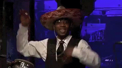 a man in a sombrero is holding a microphone in front of a sign that says chocolio