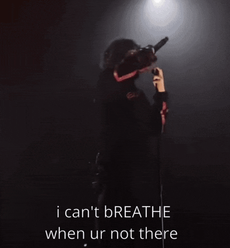 a man singing into a microphone with the words i can t breathe when ur not there