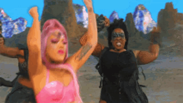 a woman with pink hair is dancing with a group of people