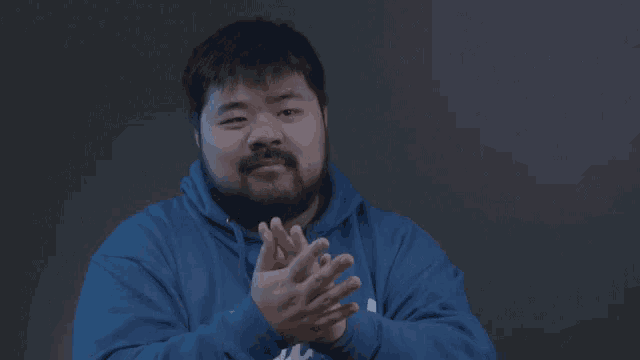 a man with a beard wearing a blue italia sweatshirt