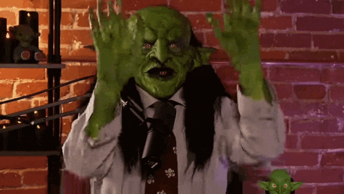 a man with a green mask on his face and hands
