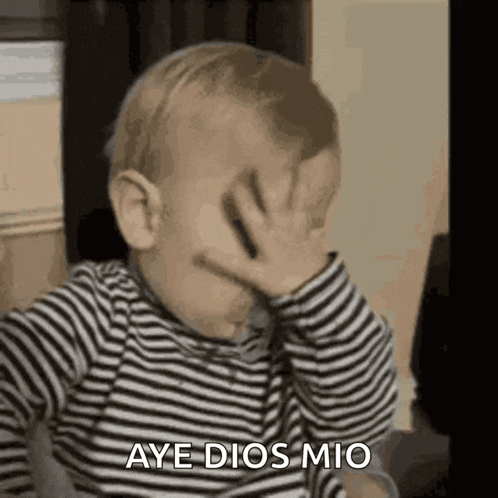 a baby is covering his face with his hand and saying aye dios mio