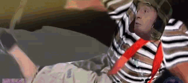 a man in a striped shirt with a red tie