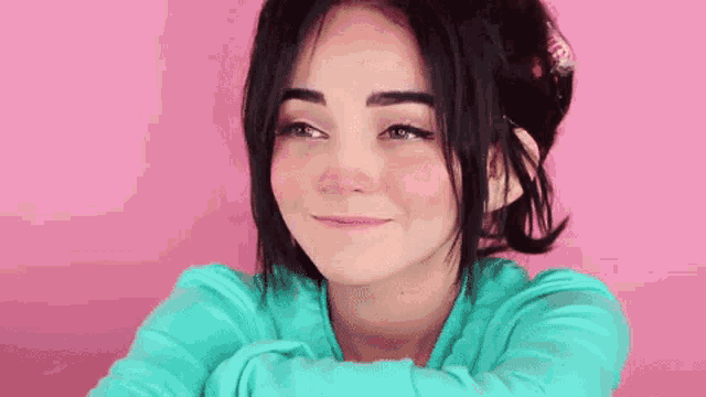 a close up of a woman 's face with her eyes closed and smiling .