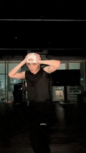 a blurry picture of a man in a white hat in a dark room