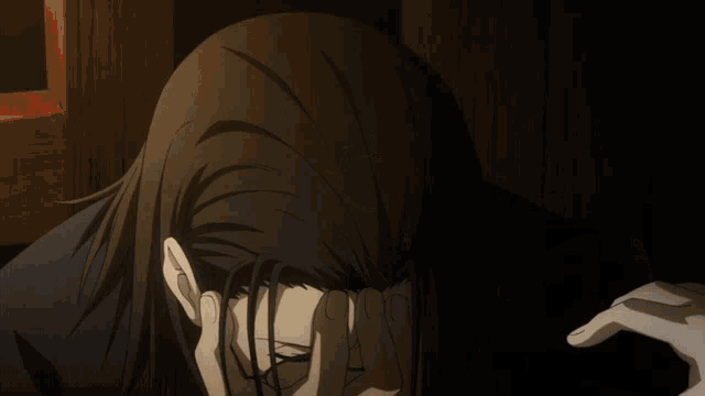 a person with a white feather in their hair covering their face