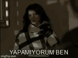 a man in a suit is standing next to a woman in a room and says yapamiyorum ben .
