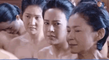 a group of women are standing next to each other without shirts on
