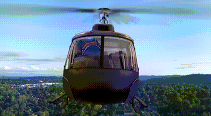 a helicopter is flying over a forest with a blue sky in the background