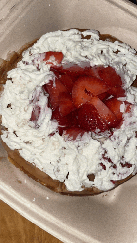 a waffle with whipped cream and strawberries on top of it
