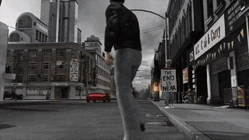 a man walking down a street holding a sign that says " the end is near "