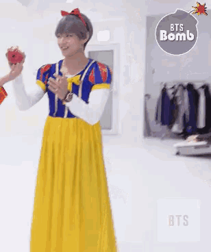 a person dressed as snow white is holding an apple in their hand