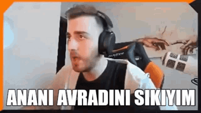 a man wearing headphones is sitting in a chair and making a funny face .